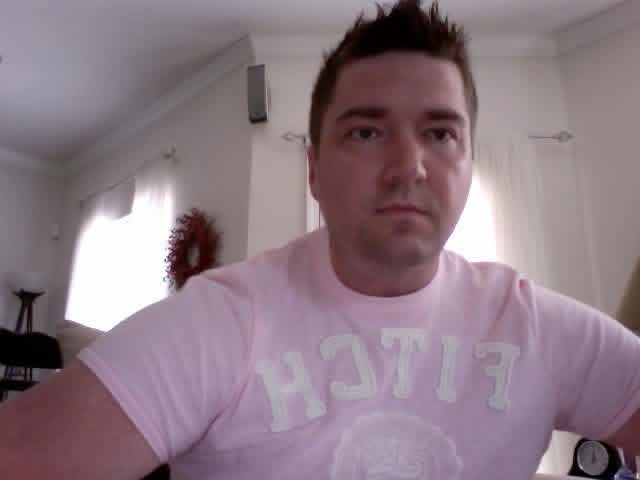 Shane at home in a pink Abercrombie & Fitch T-shirt.