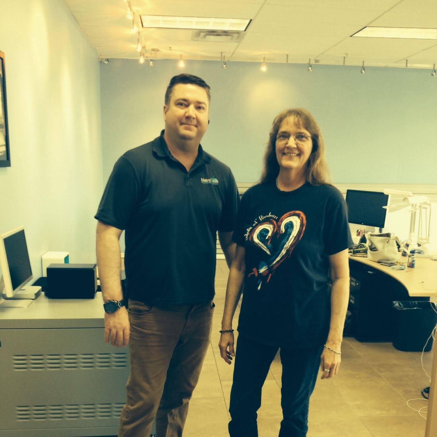 Shane in a work polo with his mother, Michele, at the phone shop.