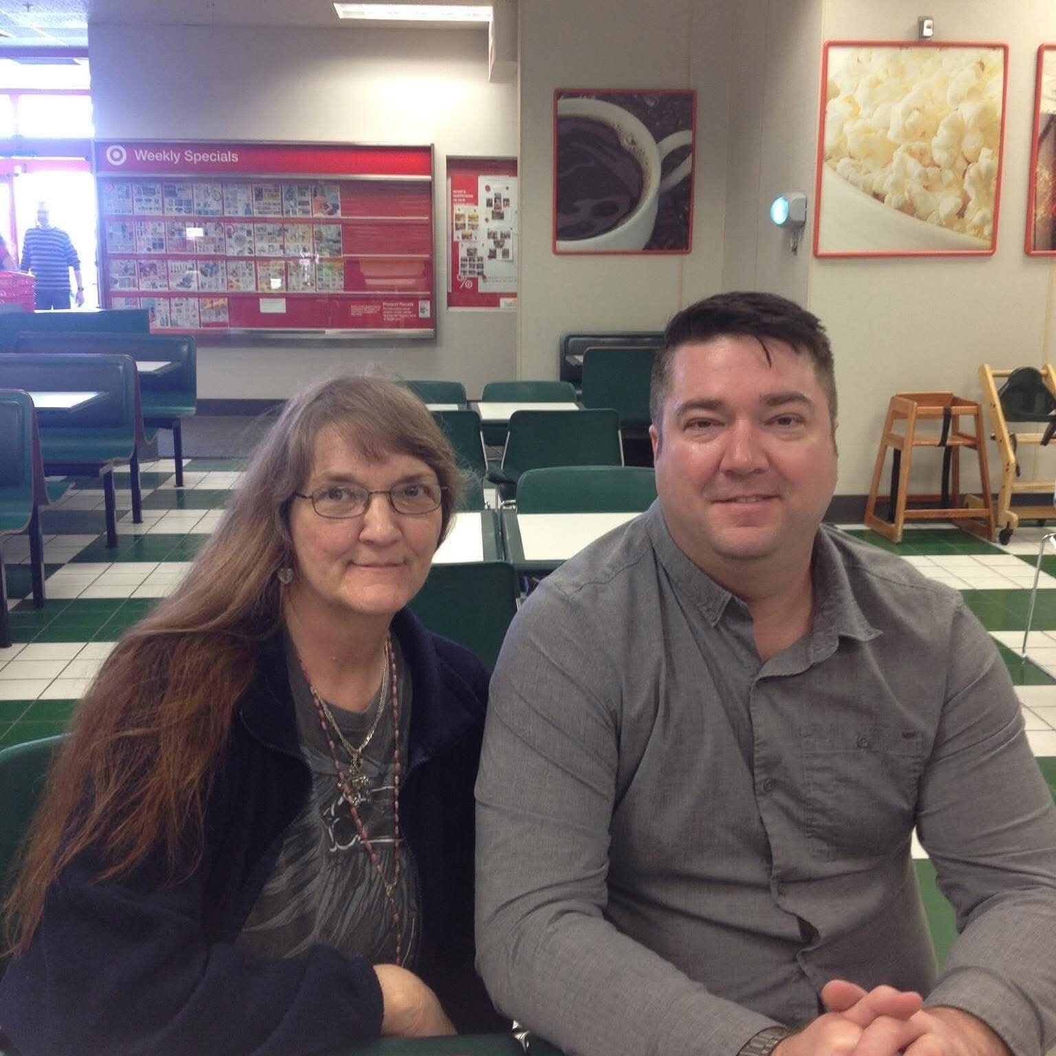 Shane and his mother, Michele, sitting together at a café.